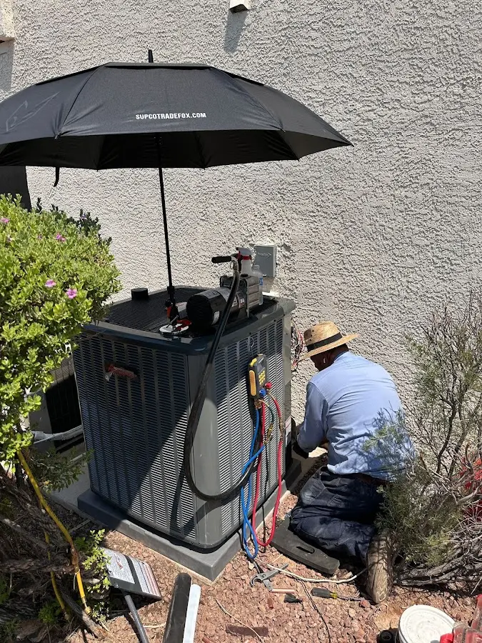 HVAC technician performing outdoor AC maintenance in Warrensville Heights
